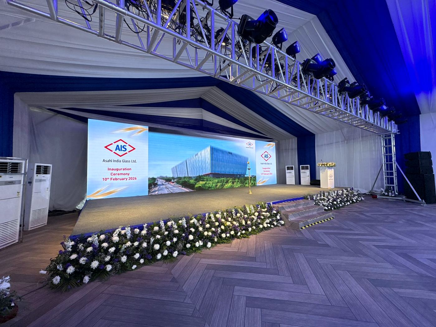 Launch stage with LED screen and flowers, tower ACs at the side